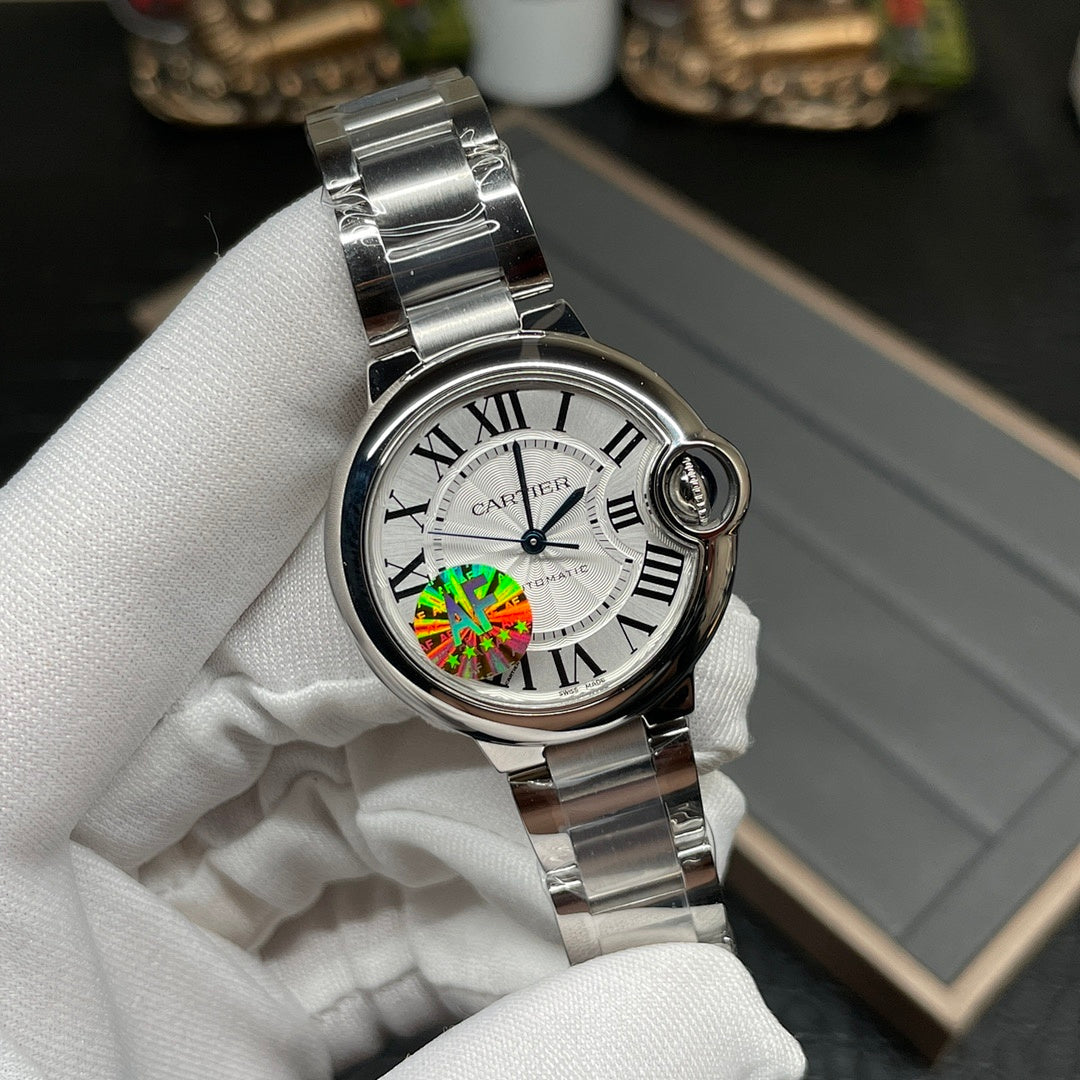 Cartier watch with silver bracelet, round white dial and Roman numerals, front close-up
