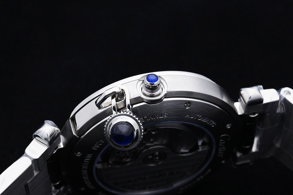 Cartier watch top view with crown and two blue accents on silver case