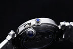 Cartier watch top view with crown and two blue accents on silver case