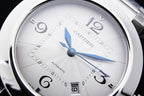 Cartier watch dial close-up with blue hands and minute markers, silver case
