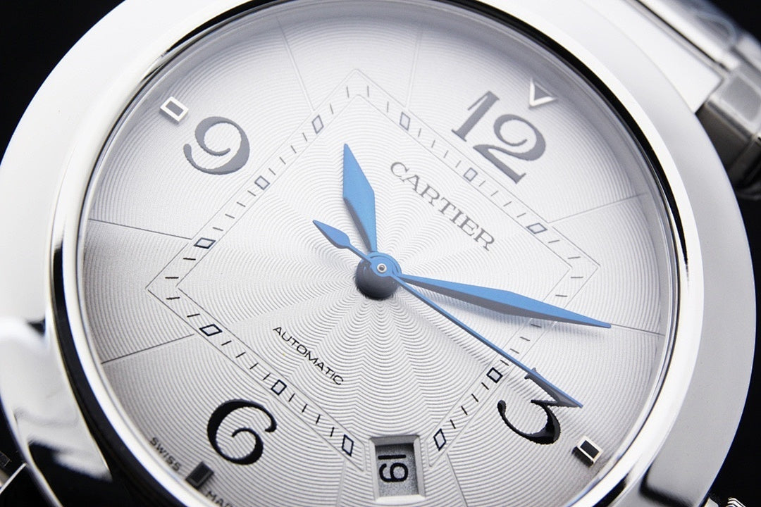 Cartier watch dial close-up with blue hands and minute markers, silver case