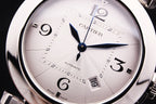 Cartier watch dial close-up with blue hands, Arabic numerals, and patterned face
