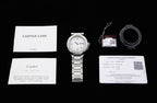 Cartier watch set with booklet, warranty card, and metal bracelet, accessories laid out