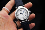 Cartier wristwatch with silver case and dark blue leather strap, round white dial