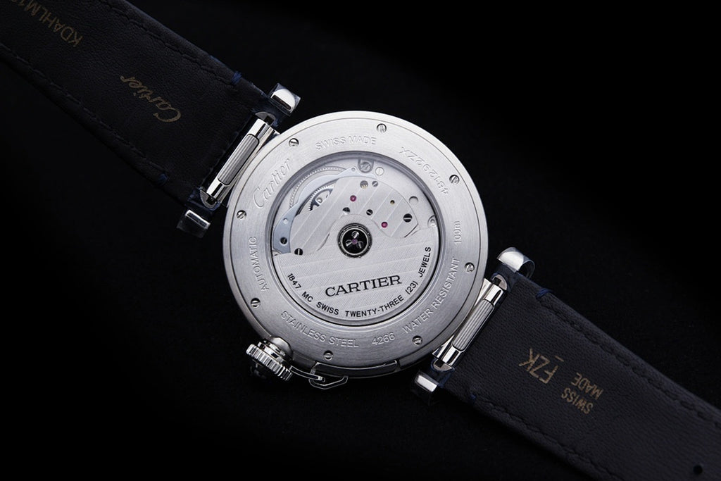 Cartier wristwatch underside view with visible movement and dark blue leather strap