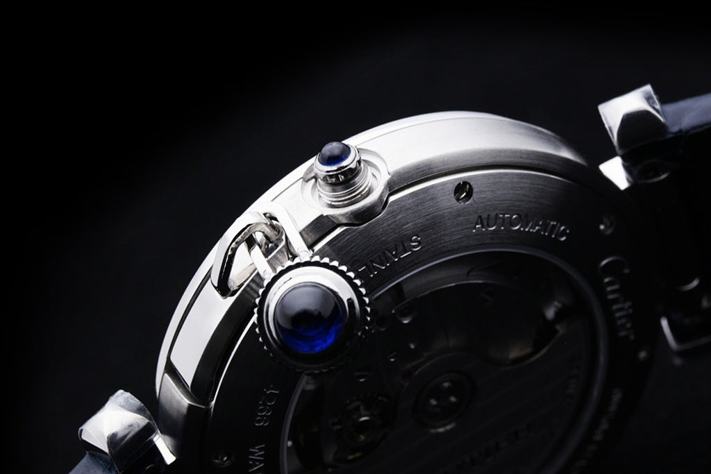 Cartier wristwatch case close-up with crown and pushers on silver frame