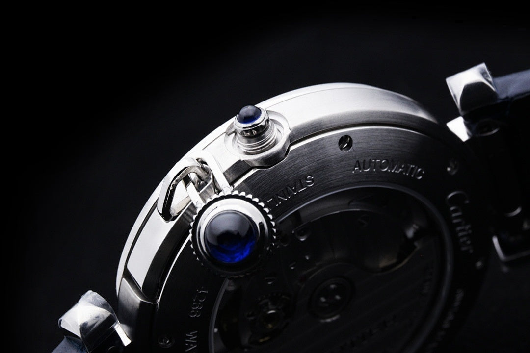 Cartier wristwatch case close-up with crown and pushers on silver frame