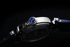 Cartier wristwatch close-up of beaded bezel and crown, dark blue leather strap