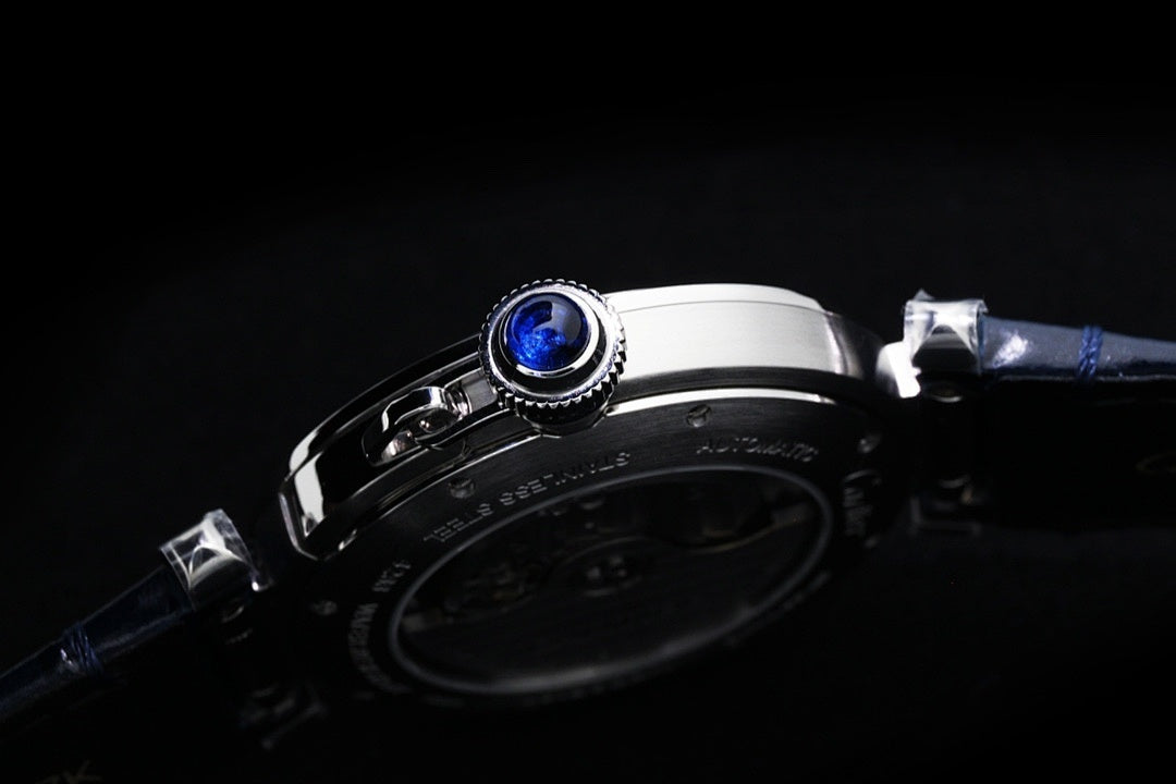 Cartier wristwatch close-up of beaded bezel and crown, dark blue leather strap