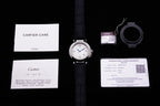 Cartier wristwatch with instruction papers, warranty card, and strap accessories