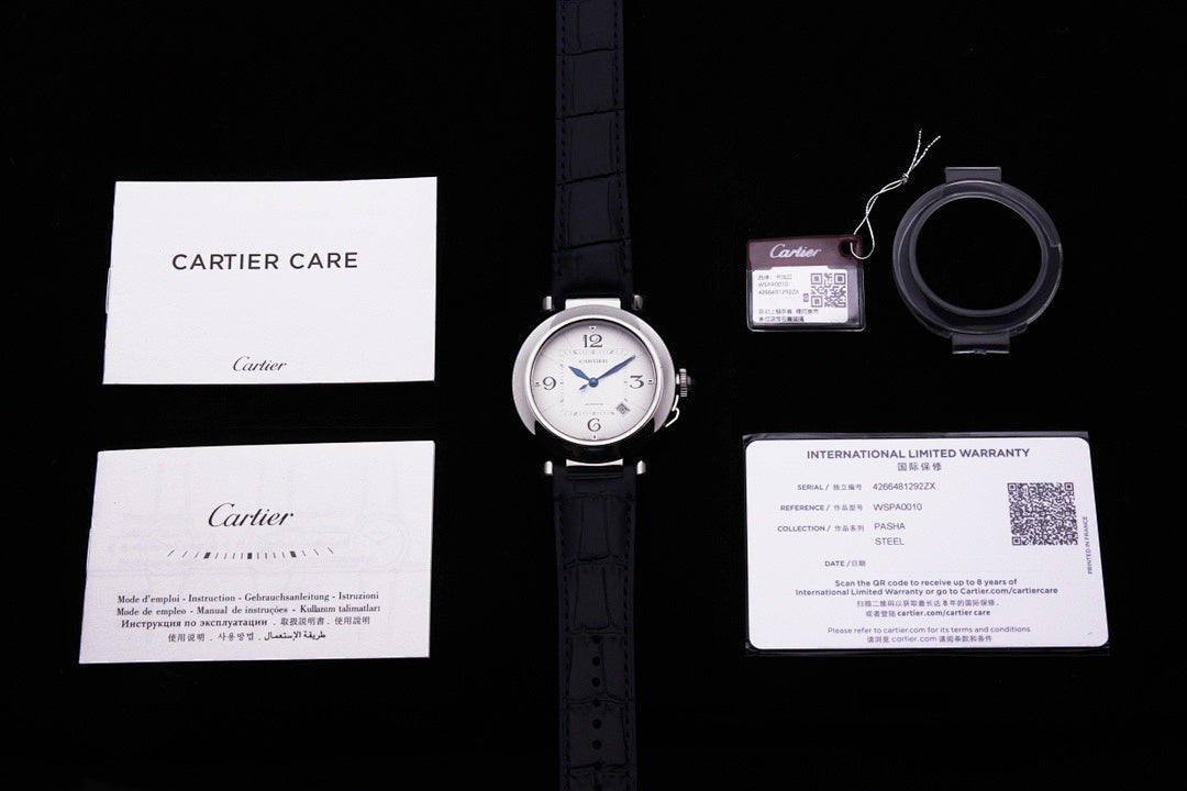 Cartier wristwatch with instruction papers, warranty card, and strap accessories