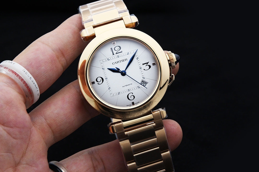 Gold-tone Cartier watch with white dial, blue hands, Roman numerals, link bracelet