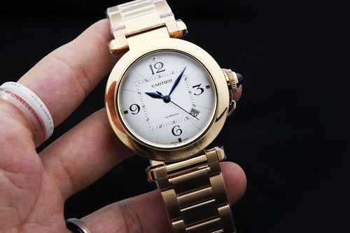 Gold-tone Cartier watch with white dial, blue hands, Roman numerals, link bracelet