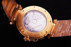Cartier watch caseback with engraved gold cover and visible movement through glass