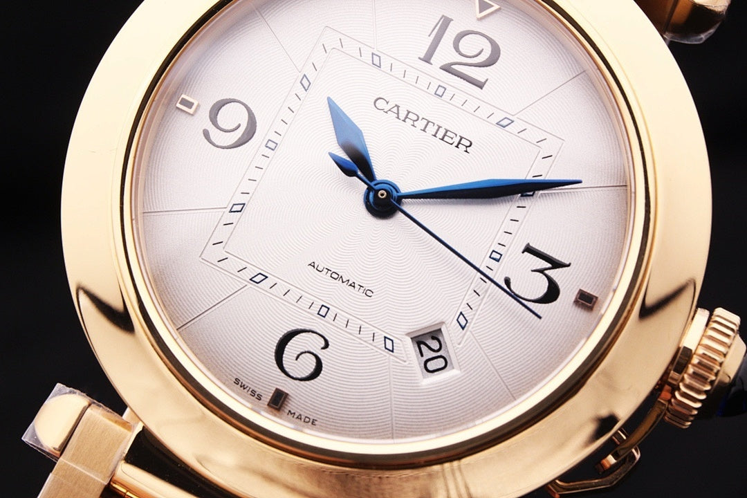 Gold-tone Cartier watch dial with Roman numerals and blue automatic hands