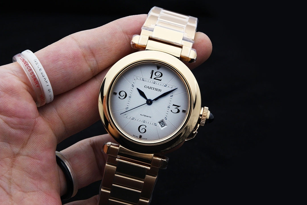 Gold-tone Cartier watch on metal bracelet with white dial and blue hands