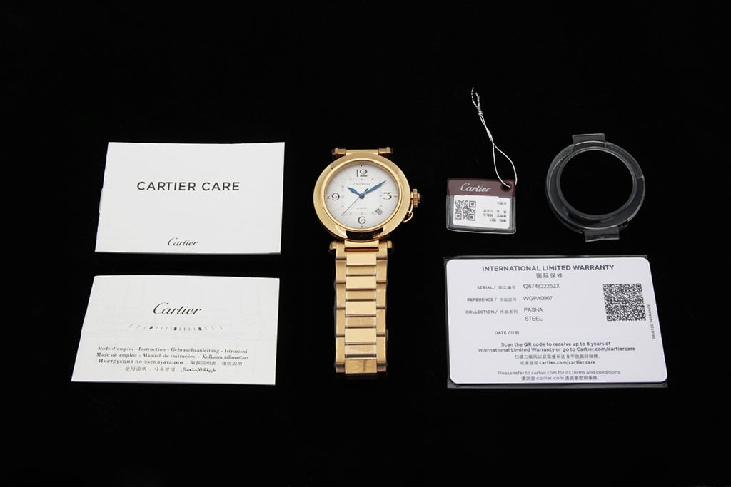 Cartier watch with warranty and care documents, gold bracelet shown