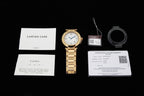 Cartier watch with warranty and care documents, gold bracelet shown