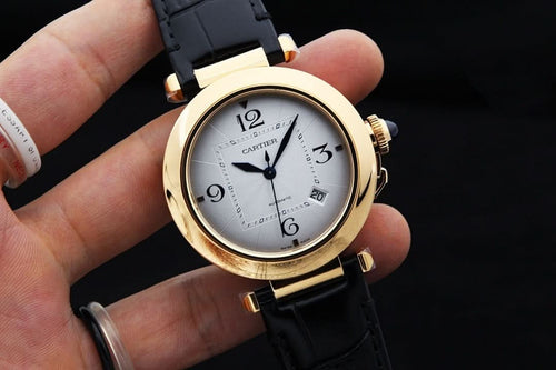 Cartier watch with white dial, gold-tone case, black leather strap and crown