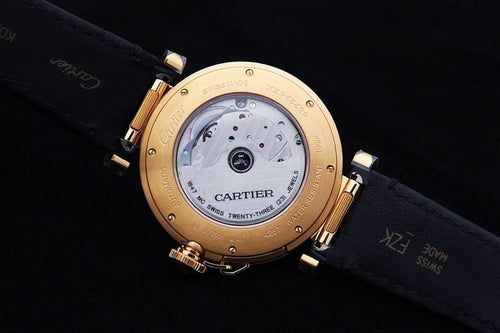 Cartier watch back with gold-tone case, dark leather strap, engraved dial details
