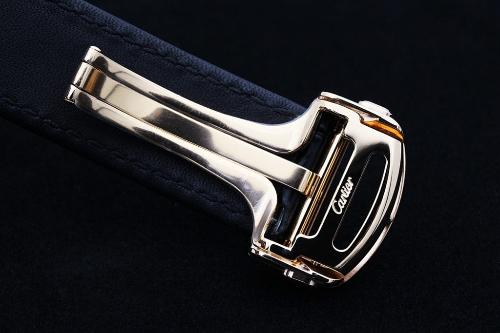 Cartier watch buckle clasp on dark leather strap with polished metal case