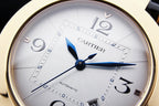 Cartier watch dial close-up with blue hands and gold-tone markers