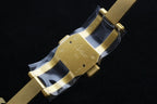 Cartier gold-tone watch clasp with engraved details on the bracelet.
