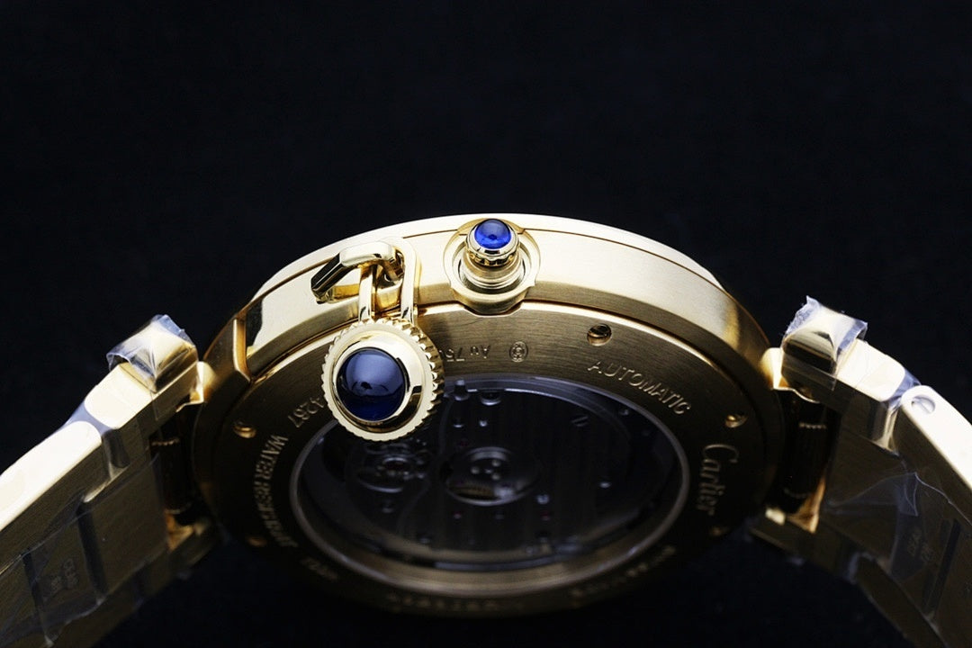Cartier gold-tone watch with crown and bezel detail featuring a blue gemstone.