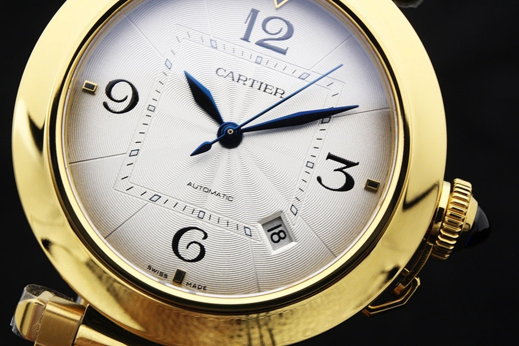 Cartier gold-tone watch face with white dial, blue hands, and link bracelet.