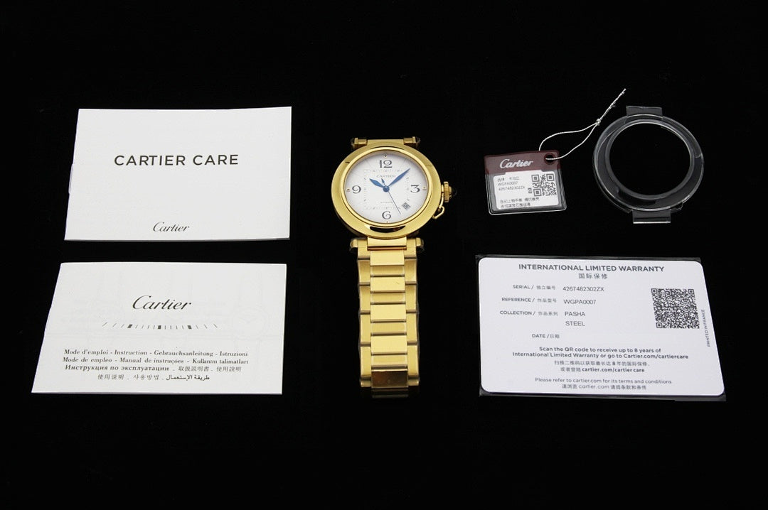 Cartier watch accessories set: watch, papers, and warranty card on display.