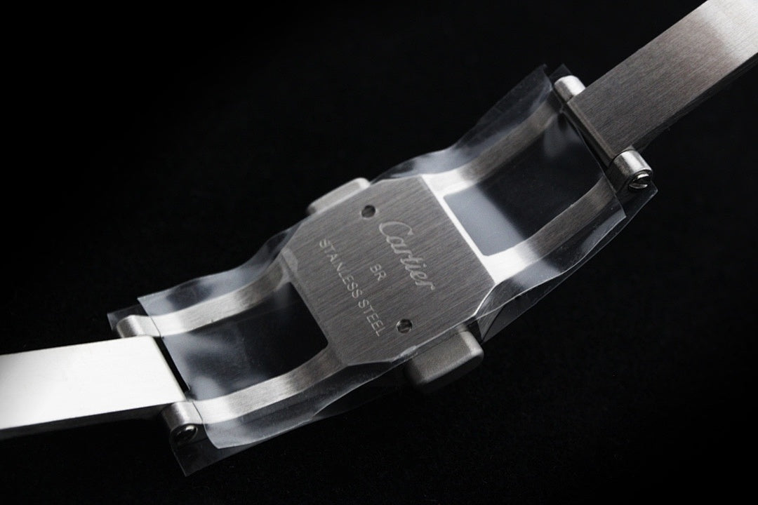 Cartier steel watch bracelet clasp and band link detail.