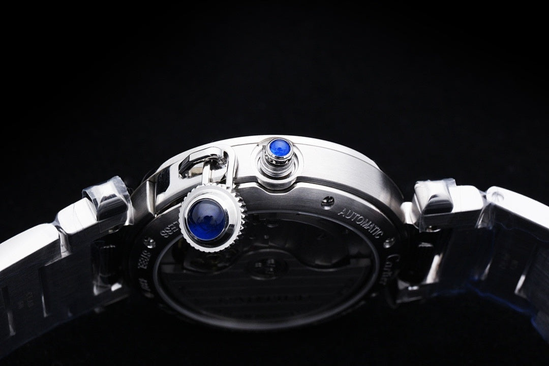 Cartier watch caseback with visible blue screw caps and stainless steel bracelet links.