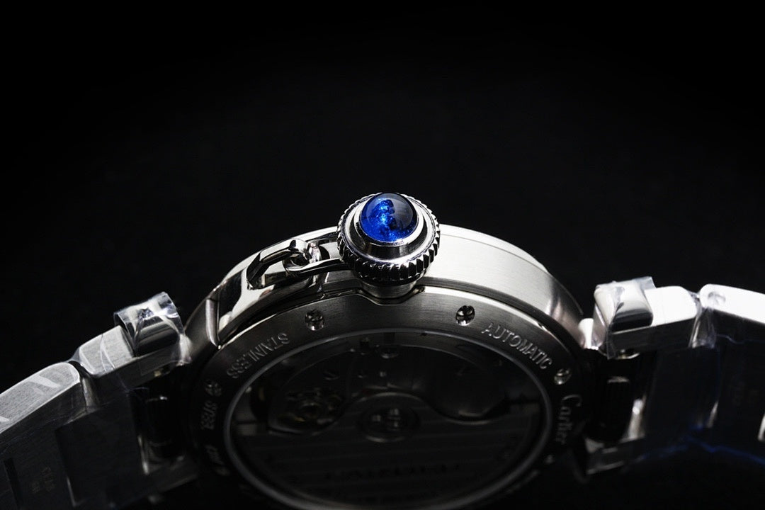 Cartier watch caseback with prominent blue screw and stainless steel band links.