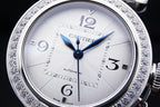 Cartier automatic wristwatch face with white dial, blue hands, diamond bezel.