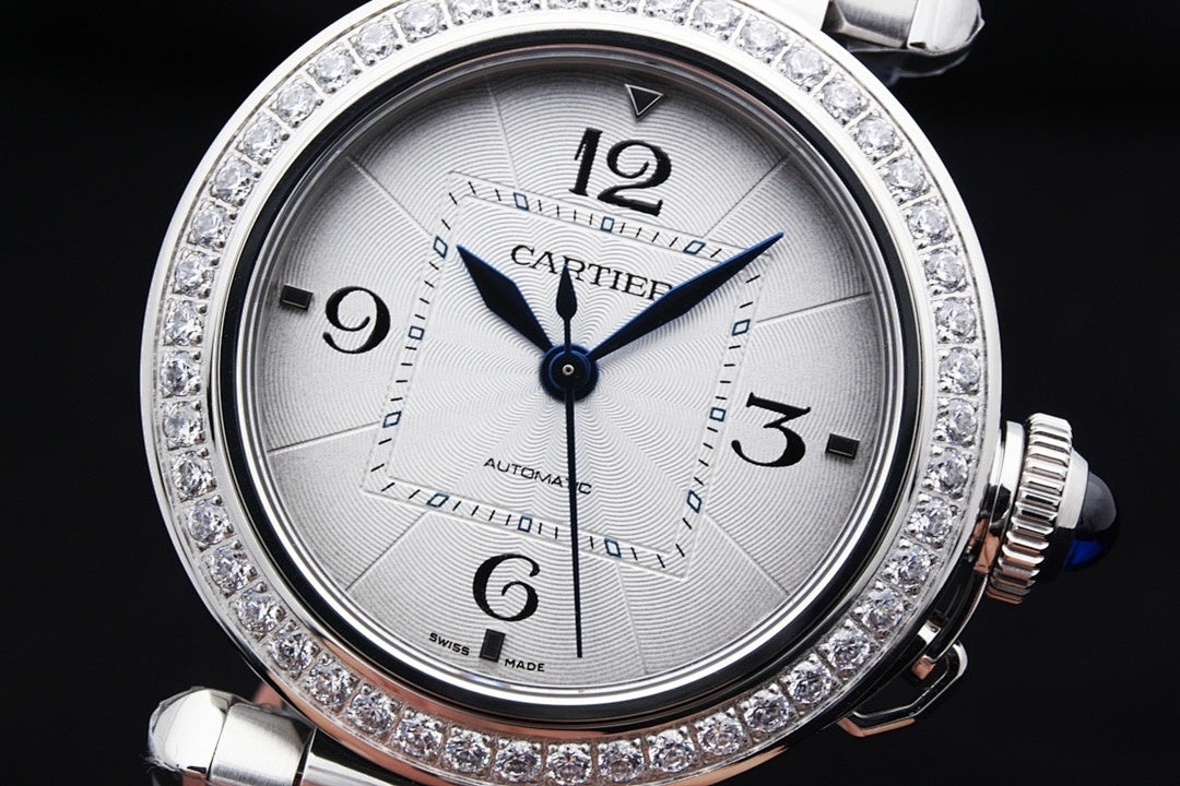Cartier automatic wristwatch with white dial, diamond bezel, silver steel case and bracelet.