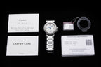 Cartier watch accessories set: care card, warranty card, strap loop, and watch.