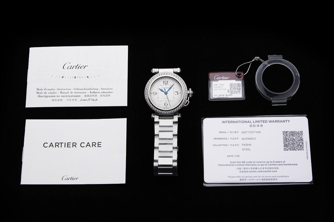 Cartier watch accessories set: care card, warranty card, strap loop, and watch.