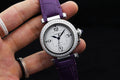 Cartier watch with purple leather strap, silver jeweled bezel, white dial