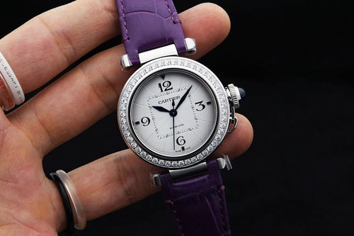 Cartier watch with purple leather strap, silver jeweled bezel, white dial