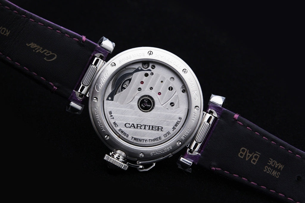 Cartier watch caseback on purple leather strap, engraved metal back plate
