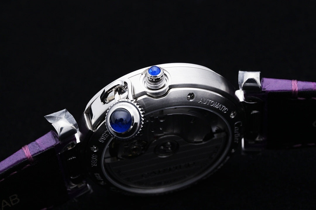 Cartier watch underside with blue jewel, purple leather strap and metal case
