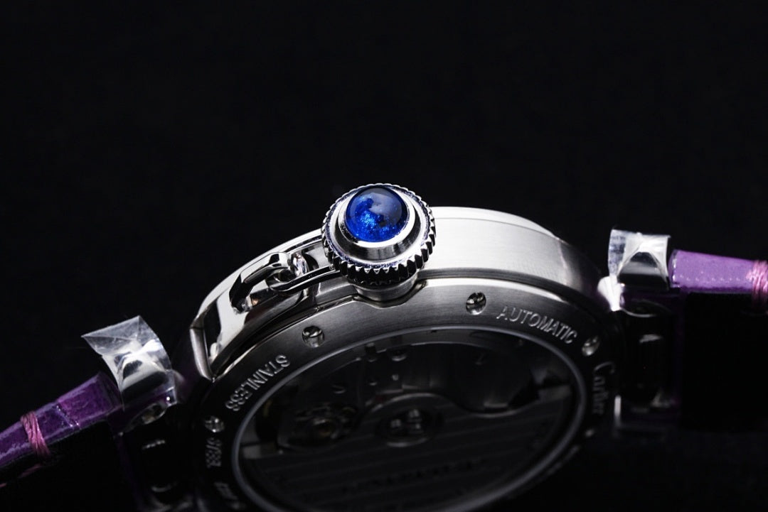 Cartier watch case with blue jewel and purple leather strap, close side view