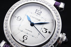 Cartier watch dial with blue hands, jeweled silver bezel, automatic on white face