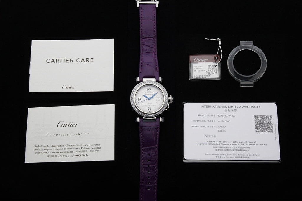 Cartier watch set with purple strap, box card, warranty card, and key fob tag