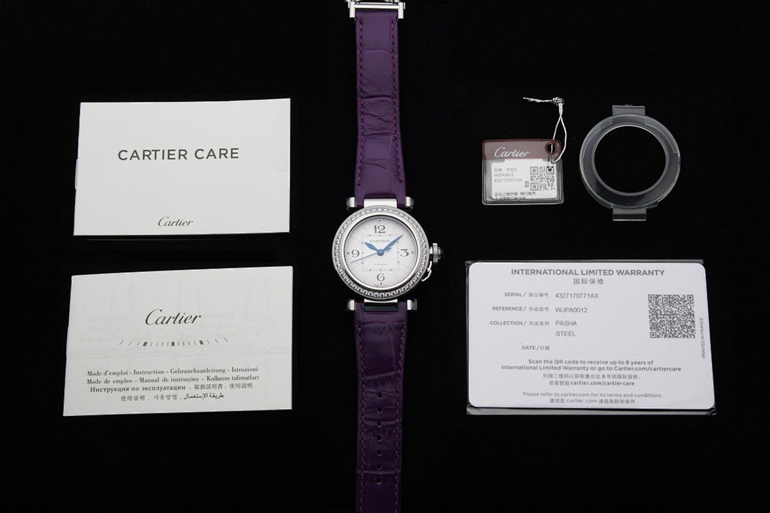Cartier watch set with purple strap, box card, warranty card, and key fob tag