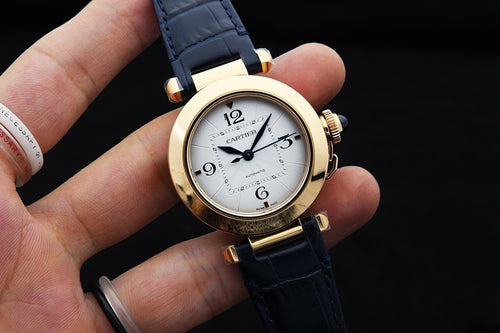 Cartier watch with blue leather strap, gold case, white dial, Roman numerals
