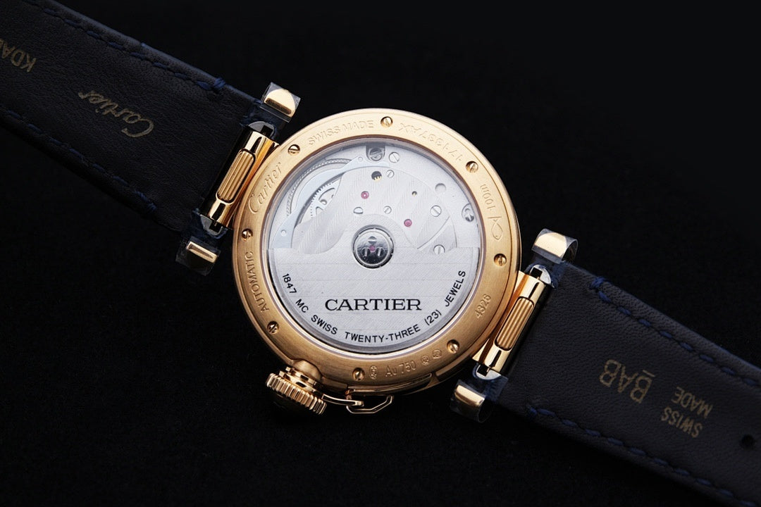 Cartier watch with blue leather strap and gold case back with markings