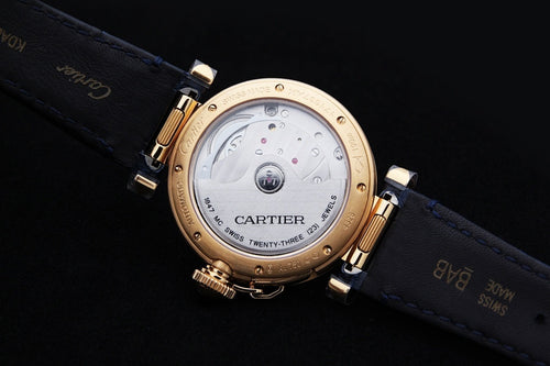 Cartier watch with blue leather strap and gold case back with markings