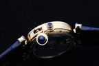Cartier watch case with blue leather strap and gold crown and blue details
