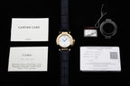Cartier watch with blue leather strap alongside warranty papers and card set